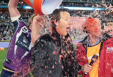 Craig Bellamy wears a Gatorade shower following the NRL Grand Final victory