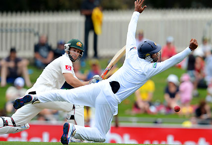 Sri Lanka's Dimuth Karunaratne (R) attempts to catch Australia's batsman Matthew Wade (L)