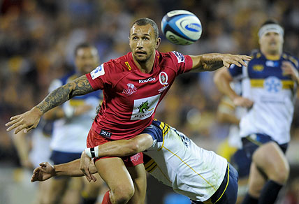 ACT Brumbies' Andrew Smith (right) tackles Queensland Reds' Quade Cooper. AAP Image/Lukas Coch