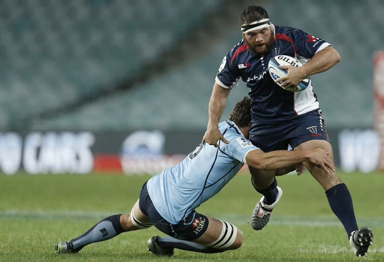 Laurie Weeks of the Melbourne Rebels is tackled by David Dennis of the NSW Waratahs. (Photo: Paul Barkley/LookPro)