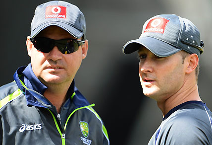 Australian cricket captain Michael Clarke (R) talks with coach Mickey Arthur (L) as Clarke struggles with a hamstring injury, in Melbourne on December 25, 2012, before Australia takes on Sri Lanka in the second cricket Test match starting on December 26 at the Melbourne Cricket Ground (MCG). AFP PHOTO/William WEST