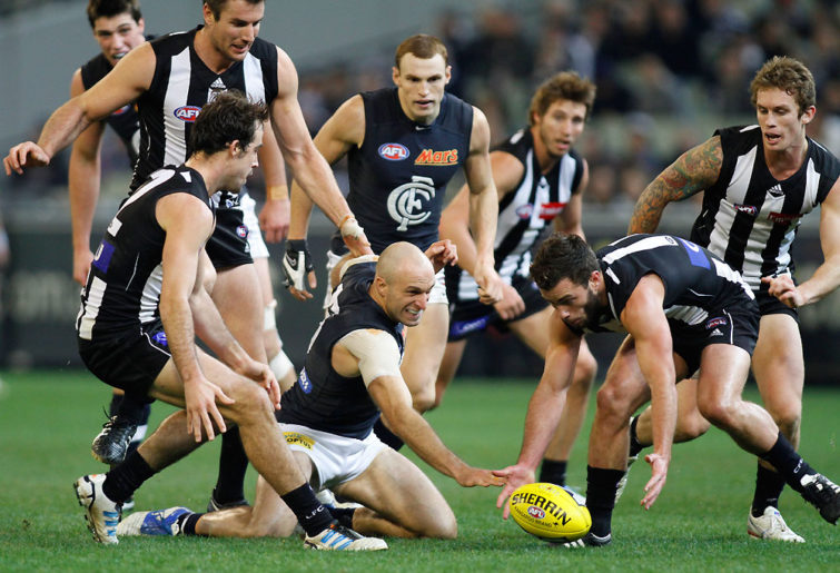 Collingwood's Jarryd Blair and Carlton's Chris Judd contest for the ball in a pack of players