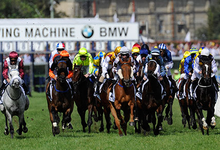 The field in the 2012 Caulfield Cup gallops down the straight the first time at Caulfield. Craig Williams won the $2.5 million race on French horse Dunaden. (AAP Image/Julian Smith)