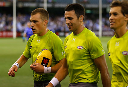 Umpires, and former players, Leigh Fisher (L) and Jordan Bannister leave the field after the 2013 NAB Cup round 01. Photo by Lachlan Cunningham