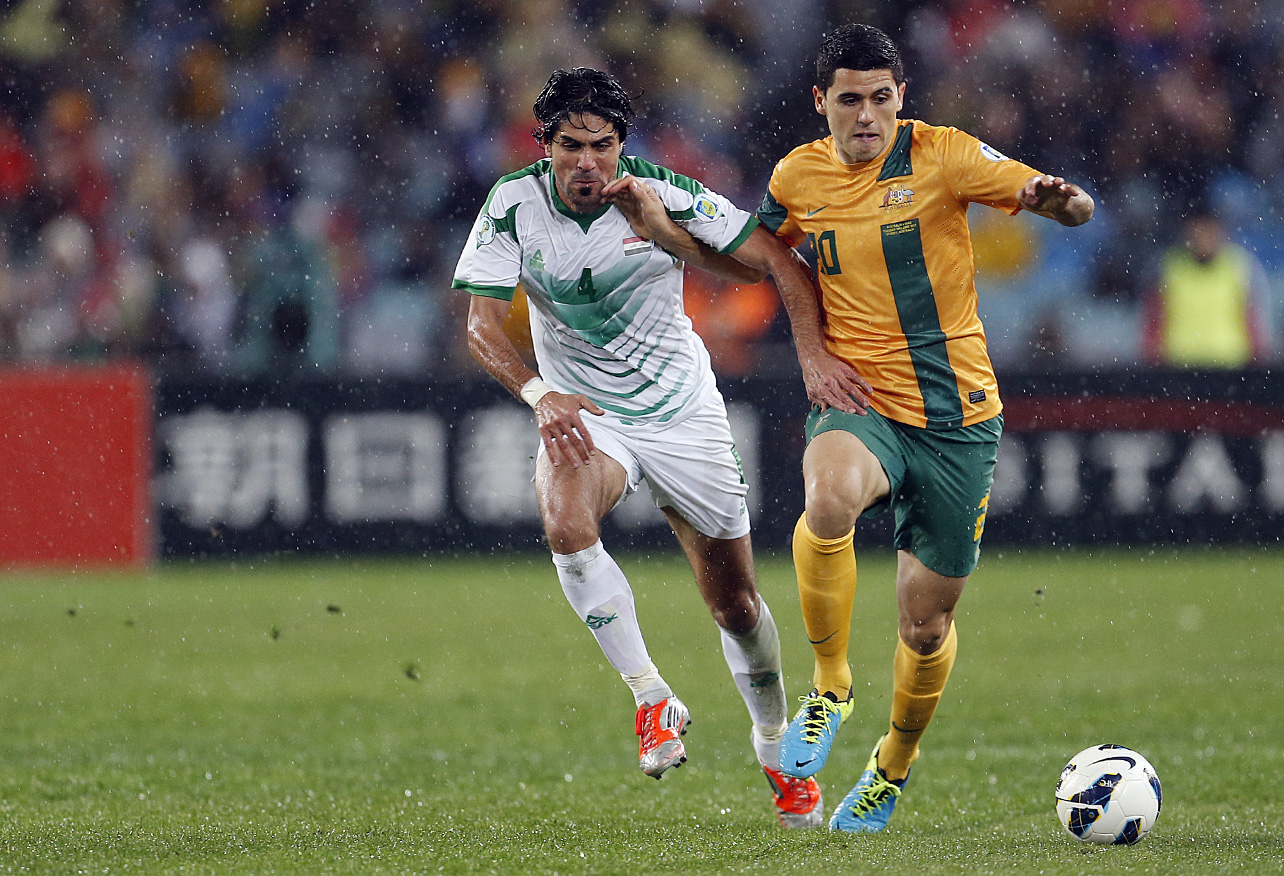 Tomas Rogic of the Socceroos tries to beat Khaldoon Ibrahim of Iraq. (Photo: Paul Barkley/LookPro)