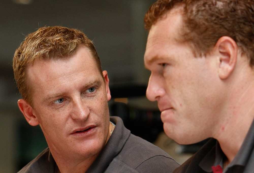 Brisbane Coach Michael Voss (L) & assistant Justin Leppitch (R) share a conversation during the 2008 NAB AFL Draft at Telstra Dome in Melbourne.