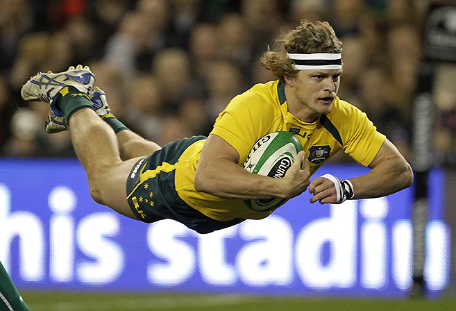 Nic Cummins dives over in the Wallabies' 32-15 win against Ireland. (AP Photo/Peter Morrison)