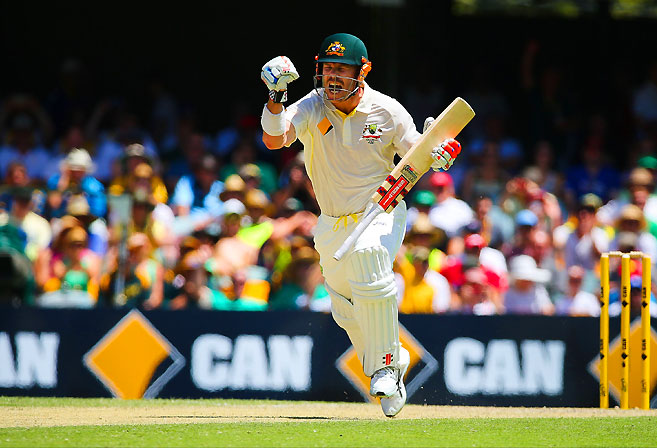 Australia's batsman David Warner celebrates his unbeaten century during day three of the first Ashes cricket Test match between England and Australia at the Gabba. AFP PHOTO / Patrick Hamilton