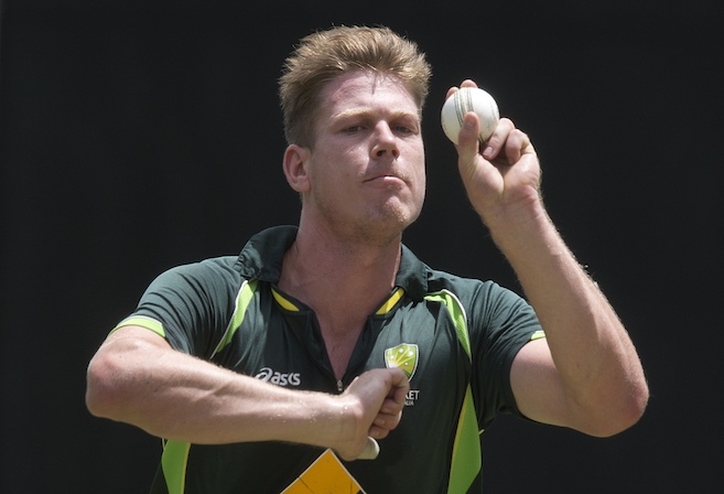 Australian cricketer James Faulkner bowls during the Australian team training session at the Gabba in Brisbane, Thursday, Jan. 16, 2014. Australia play England in the first One Day International at the Gabba tomorrow. (AAP Image/Dave Hunt) NO ARCHIVING
