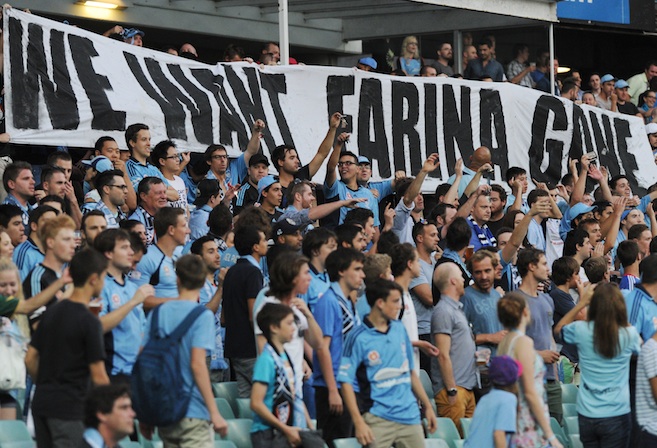 Sydney FC fans in what's known as 'The Cove' hold up a banner calling for the sacking of Sydney FC coach Frank Farina  (AAP Image/Dean Lewins) 