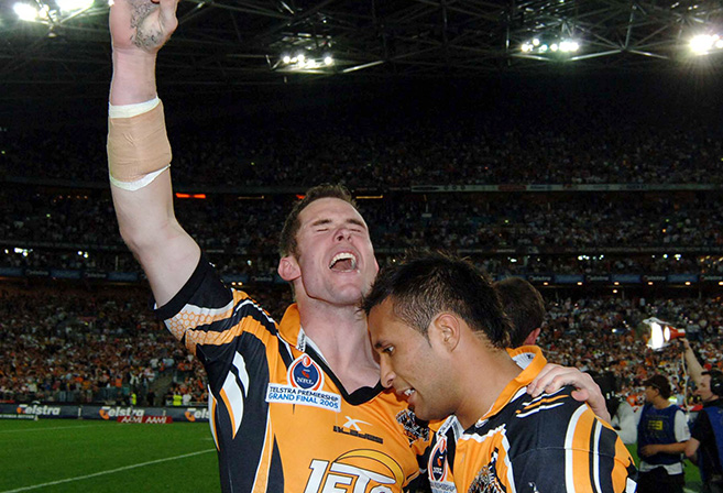 Tigers players Pat Richards and Paul Whatuira celebrate winning the NRL Rugby League Grand Final between the Wests Tigers and North Queensland Cowboys at Sydney Olympic Stadium, Sunday October 2nd 2005. The Tigers won 30-16. (AAP Image/Action Photographics/Matt Impey)