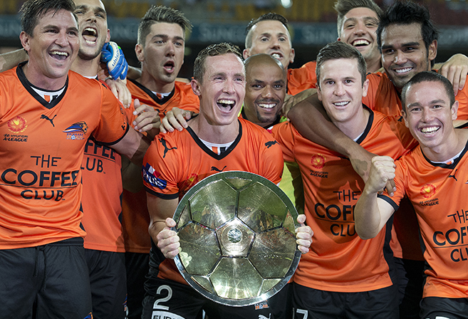 Roar captain Matthew Smith (centre) celebrates the teams minor Premiership following the Round 24 A-League match between the Brisbane Roar and Melbourne Victory at Suncorp Stadium in Brisbane, Saturday, March 22, 2014. (APP Image/Dave Hunt)