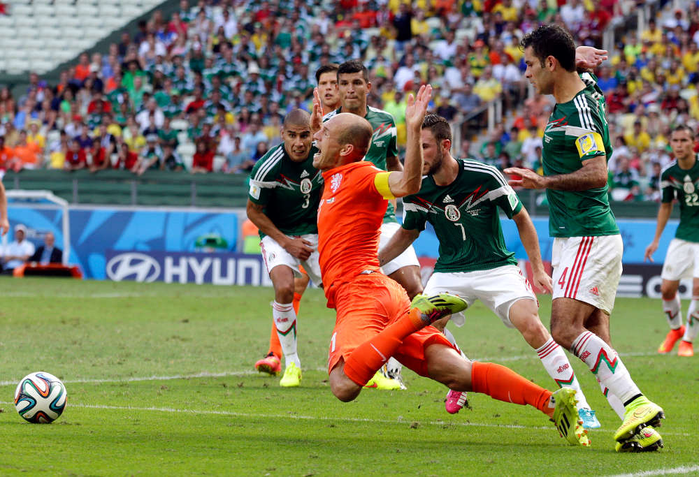 Arjen Robben takes a hit for the Netherlands in the World Cup (Photo: AP)