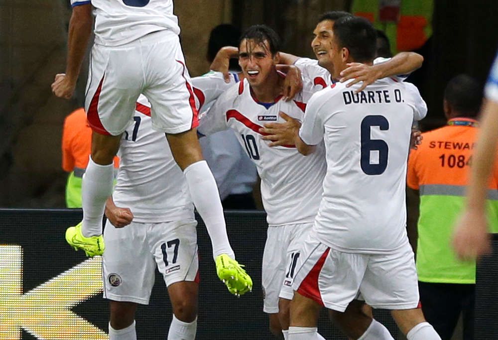 Costa Rica's Bryan Ruiz, centre, celebrates with teammates after scoring the opening goal during the World Cup round of 16 match