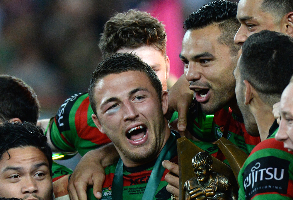 Rabbitohs players celebrates with the premiership trophy after winning the 2014 NRL Grand Final match between the South Sydney Rabbitohs and the Canterbury-Bankstown Bulldogs at ANZ Stadium in Sydney, Sunday, Oct. 5, 2014. (AAP Image/Dean Lewins)