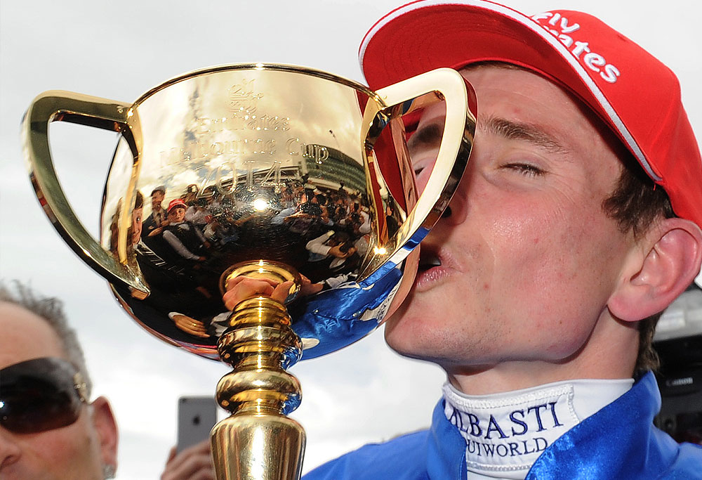 Ryan Moore kisses the Melbourne Cup after he rode Protectionist to victory at the 2014 Melbourne Cup