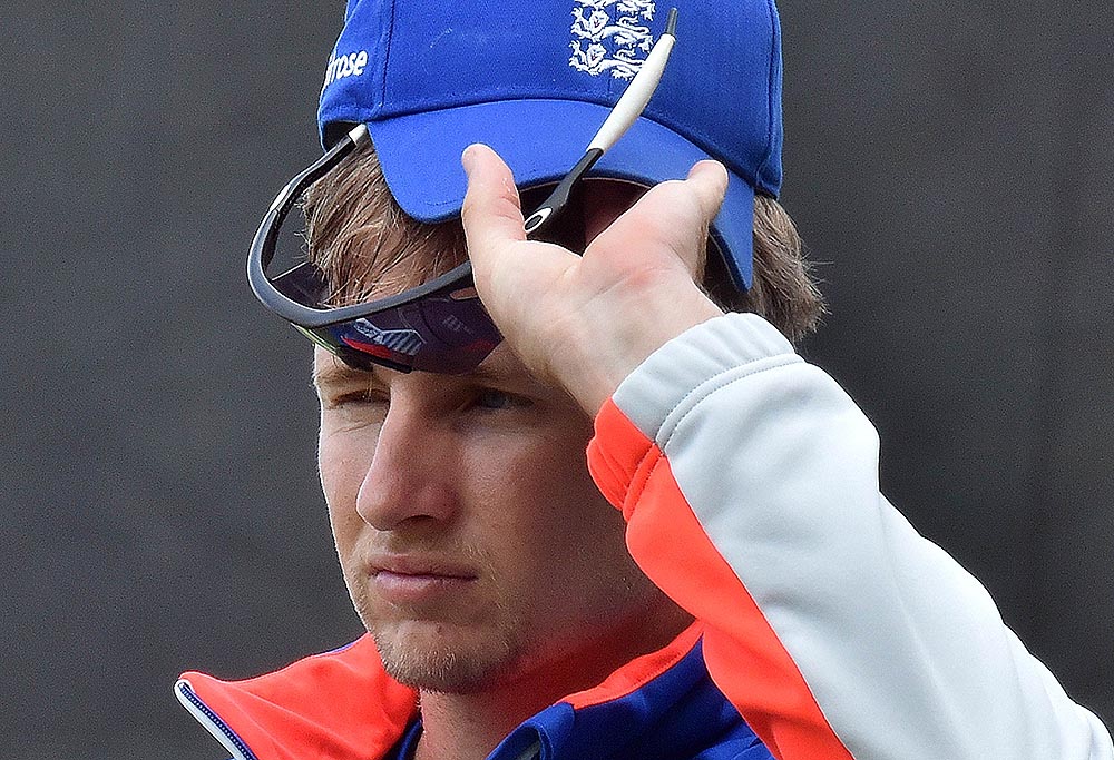 England's player Joe Root adjusts his shades and cap during a training session at Adelaide Oval on March 8, 2015. AFP PHOTO / Saeed KHAN --