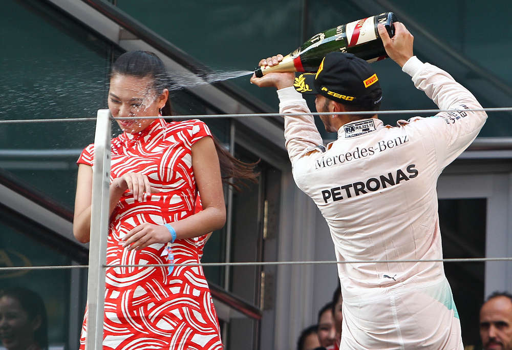 Lewis Hamilton inundating a hostess with bubbly