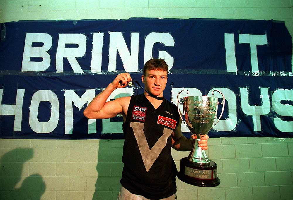 Brent Harvey for Victoria in the rooms with the trophy and the E.J Whitten Medal