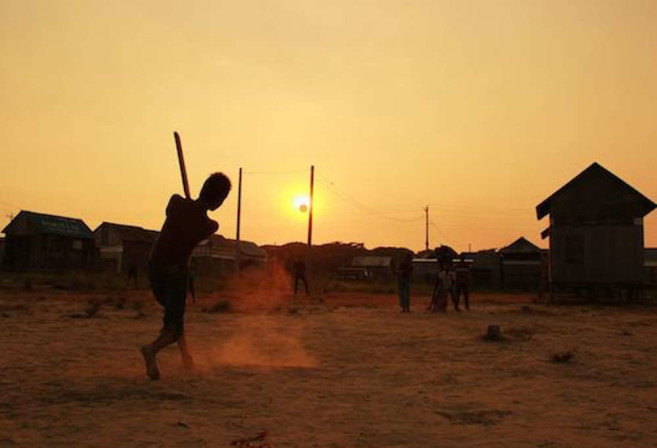 village boys playing cricket during the sunset in Bangladesh
