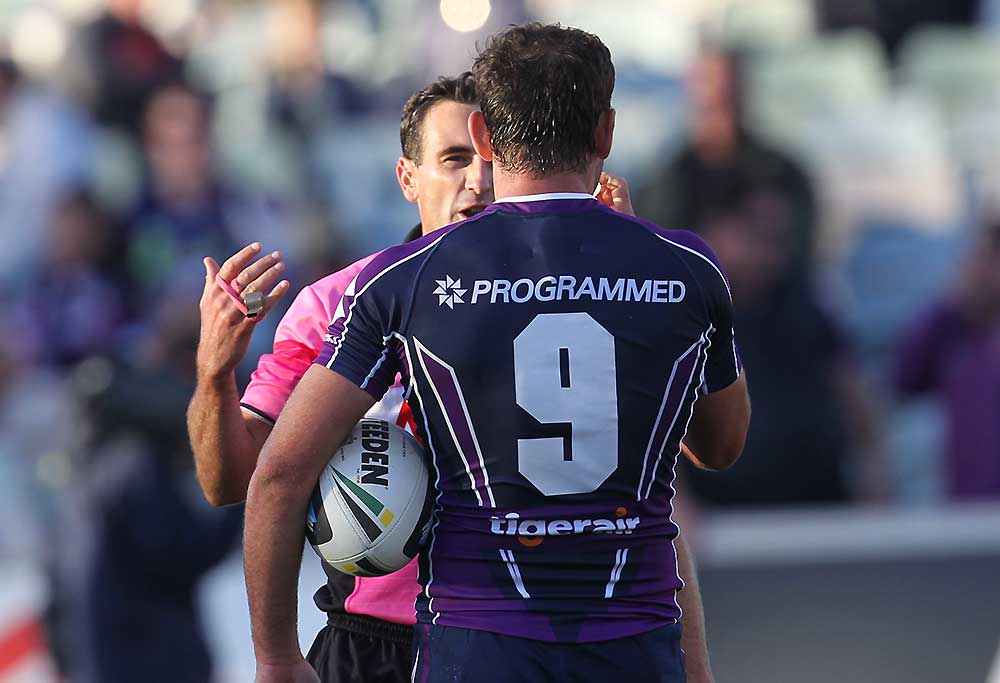 Referee Gerard Sutton explains why a try was disallowed to Storm captain Cameron Smith