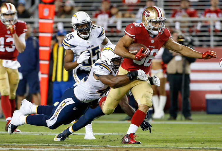 Jarryd Hayne of the San Francisco 49ers tackled by the San Diego Chargers