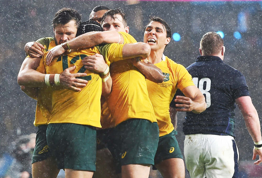 Australian players celebrate their win over Scotland