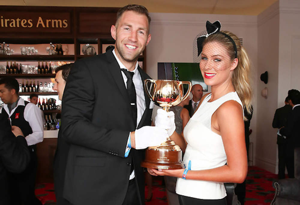 Travis Cloke and Rebeccah Penozza with the Melbourne Cup on Derby Day