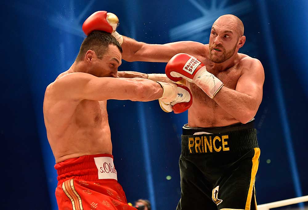 Ukraine's Wladimir Klitschko, left, and Britain's Tyson Fury, right, exchange blows