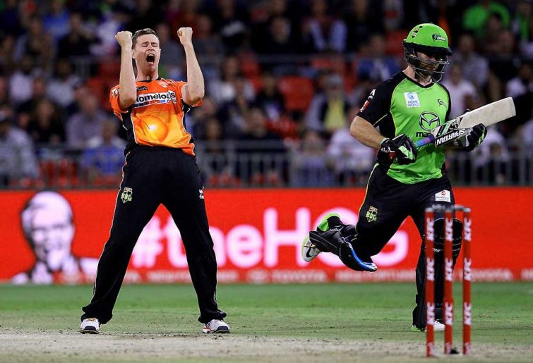 Jason Behrendorff of the Scorchers takes the wicket of the Thunder's Aiden Blizzard