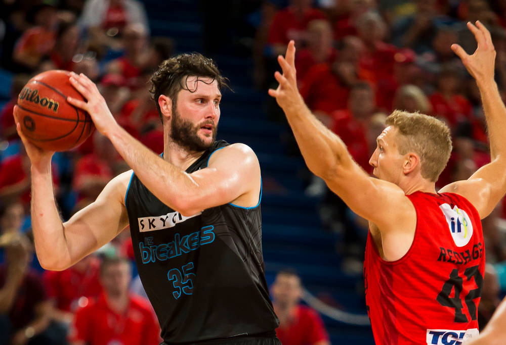 Alex Pledger and Shawn Redhage compete for the basketball