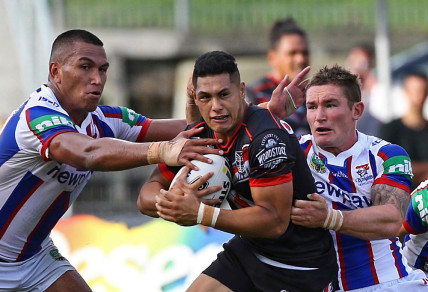 Jacob Saifiti, left, and Tyler Randell of the Newcastle Knights tackle Roger Tuivasa-Sheck of the Warriors