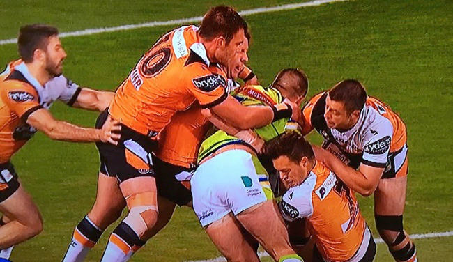 Tigers players tackling Canberra player