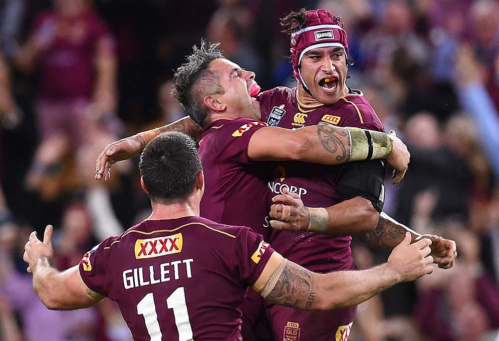 Johnathan Thurston of the Queensland Maroons (right) and teammate Corey Parker celebrate winning