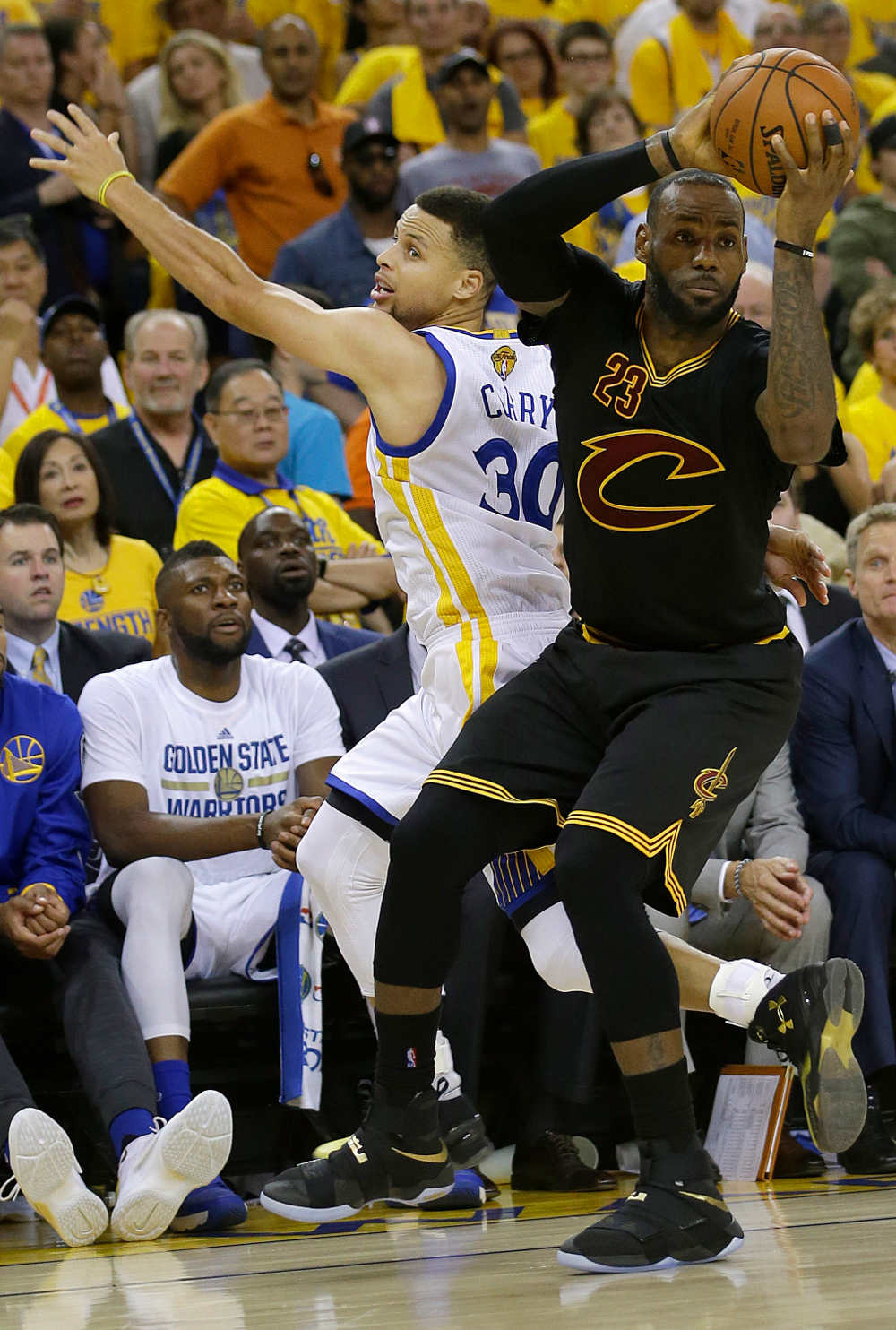 Cleveland Cavaliers forward LeBron James is defended by Golden State Warriors guard Stephen Curry