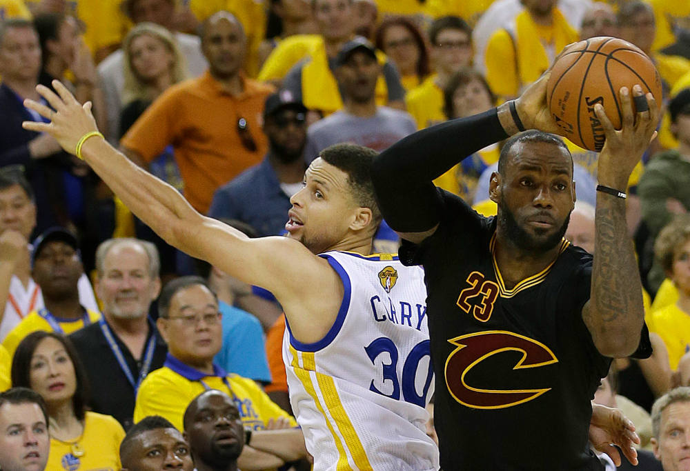 Cleveland Cavaliers forward LeBron James is defended by Golden State Warriors guard Stephen Curry