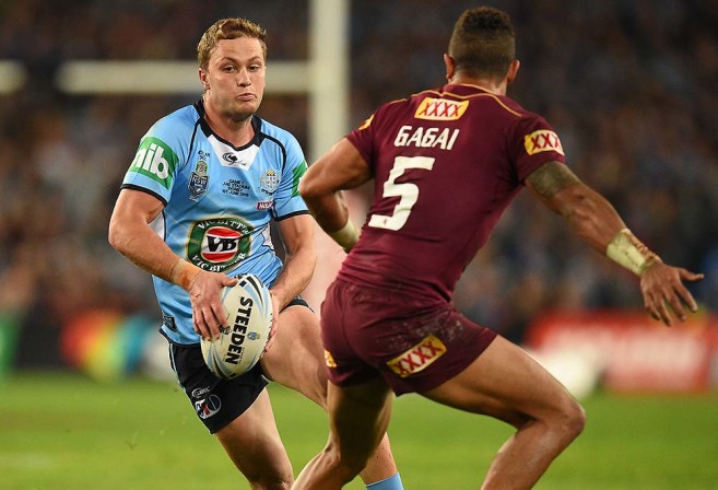 Matt Moylan of the Blues tries to avoid a tackle by Dane Gagai of the Maroons