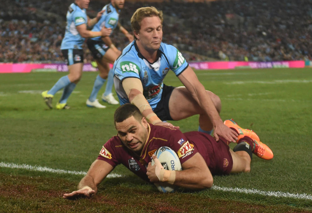 Greg Inglis of the Maroons scores a try as Matt Moylan tackles