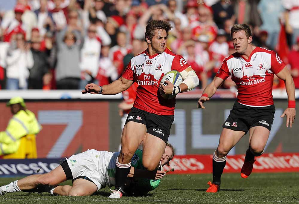 Lions Rohan Janse van Rensburg, middle, avoids a tackle from Highlanders's Matt Faddes, bottom, as teammate Ruan Combrinck, runs along during a Super Rugby semifinal match at Ellis Park stadium in Johannesburg, South Africa, Saturday, July 30, 2016. (AP Photo/Themba Hadebe)