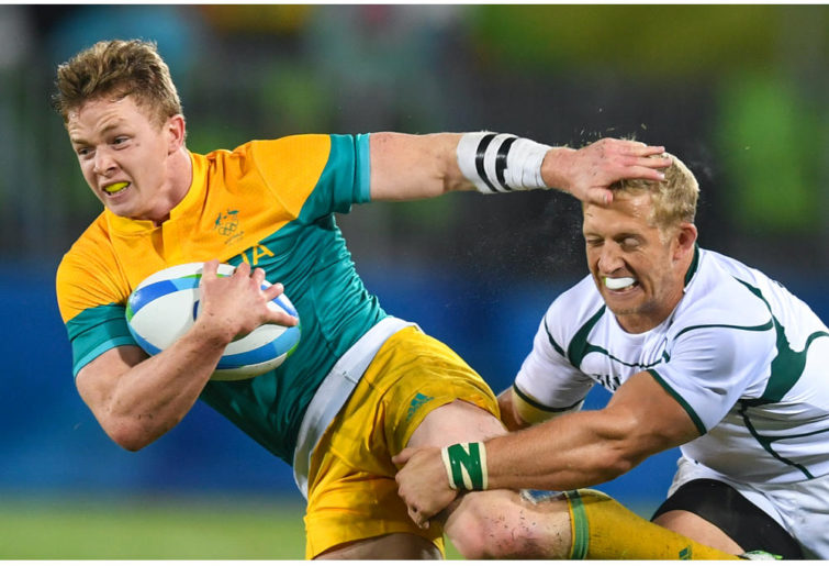 Henry Hutchinson for Australia fending off a South African defender during the Rugby Sevens at the Rio 2016 Olympics