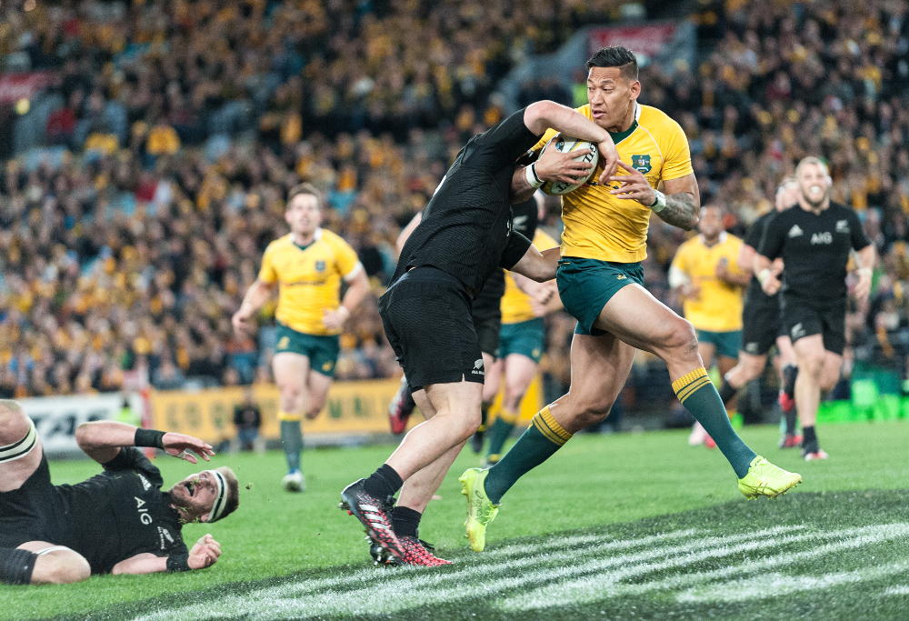 Israel Folau tries to break the tackle of Dane Coles