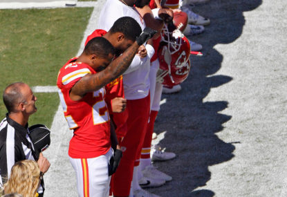 NFL player raises fist during US national anthem