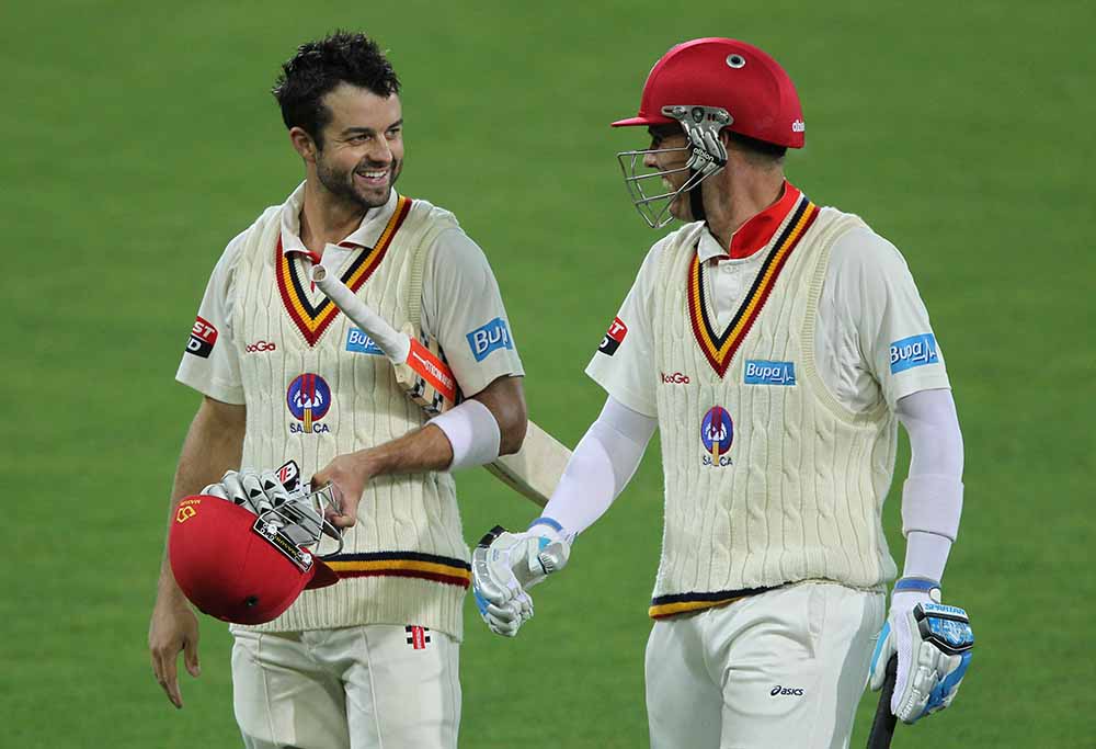 Callum Ferguson left and Johan Botha of the Redbacks walk of the ground at the end of play during day three of the Sheffield Shield match between the West End Redbacks and the NSW Blues at Adelaide Oval in Adelaide, Wednesday, March 5, 2014. (AAP Image/James Elsby)