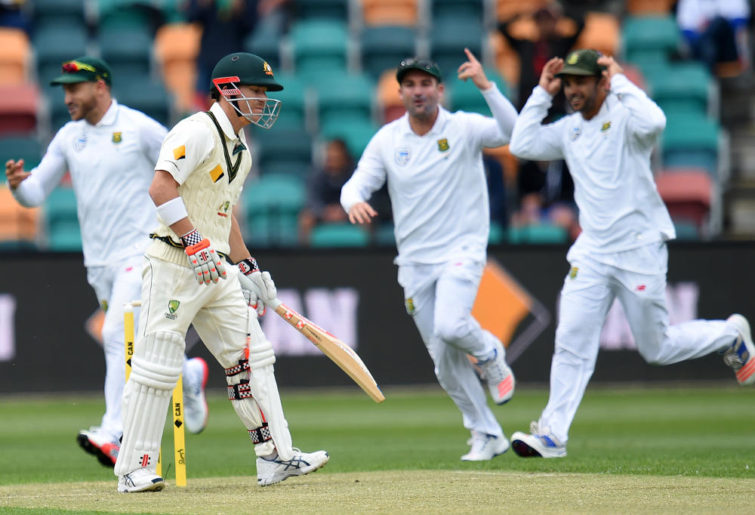 South Africa's teammates celebrate the wicket of Australia's David Warner
