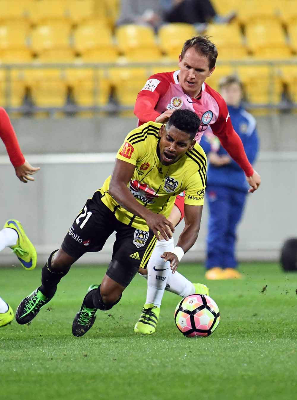 Roy Krishna of the Phoenix (left) is tackled by Neil Kilkenny of Melbourne during the Round 1 A-League match between the Wellington Phoenix and Melbourne City at Westpac Stadium in Wellington, New Zealand, Saturday, Oct. 8, 2016. (AAP Image/SNPA, Ross Setford)