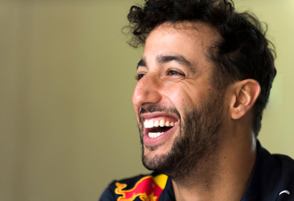 Daniel Ricciardo of Red Bull laughs during an interview with Formula One reporters.