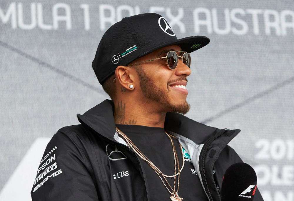 Mercedes' Lewis Hamilton smiles at a Formula One press conference.