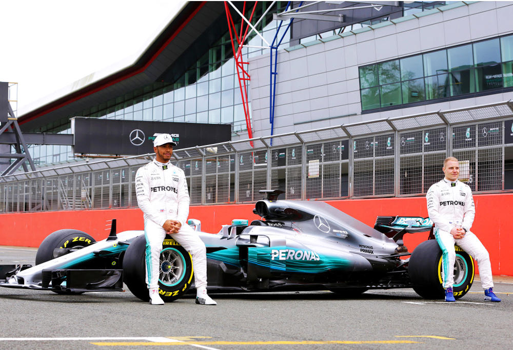Formula One drivers Lewis Hamilton and Valtteri Bottas unveil Mercedes' new car - the Silver Arrow.
