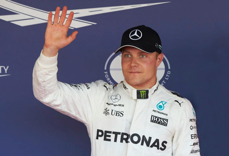 Valtteri Bottas of Mercedes waves to Formula One fans and media.
