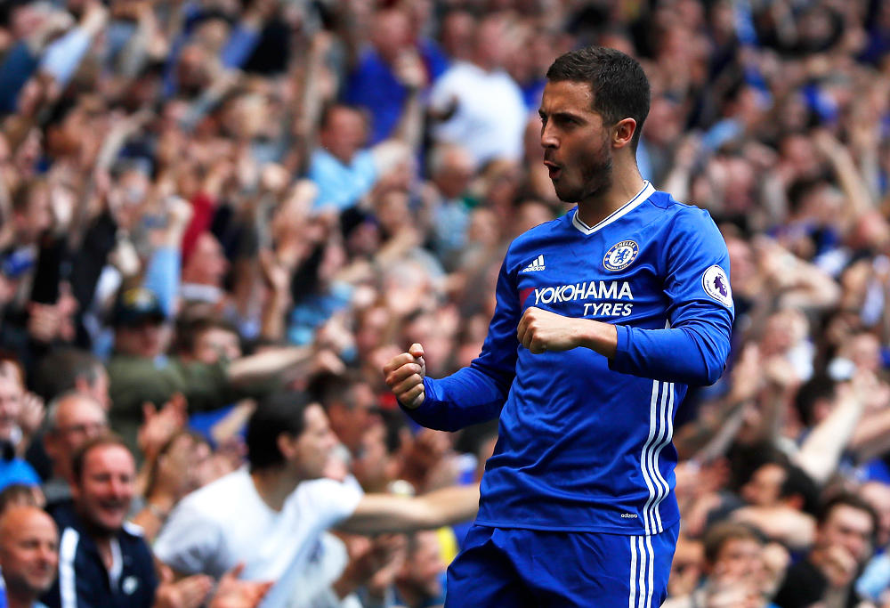 In this Sunday, May 21, 2017 file photo, Chelsea's Eden Hazard celebrates after scoring his side's second goal during their English Premier League soccer match against Sunderland at Stamford Bridge stadium in London. Eden Hazard will be joined at Premier League champion Chelsea by his younger brother, Kylian. The London club says the 22-year-old Kylian Hazard signed Tuesday, Aug. 29 for the development squad.